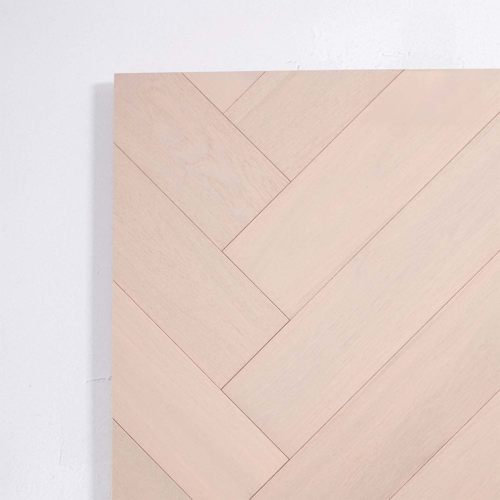 Detailed view of Casper White Engineered Timber Herringbone 15.3mm in Casper White colour light tone herringbone flooring sample