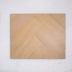 Flat lay of French Oak SPC Hybrid Floorboards Herringbone 7.5+2mm in French Oak colour warm tone herringbone flooring sample