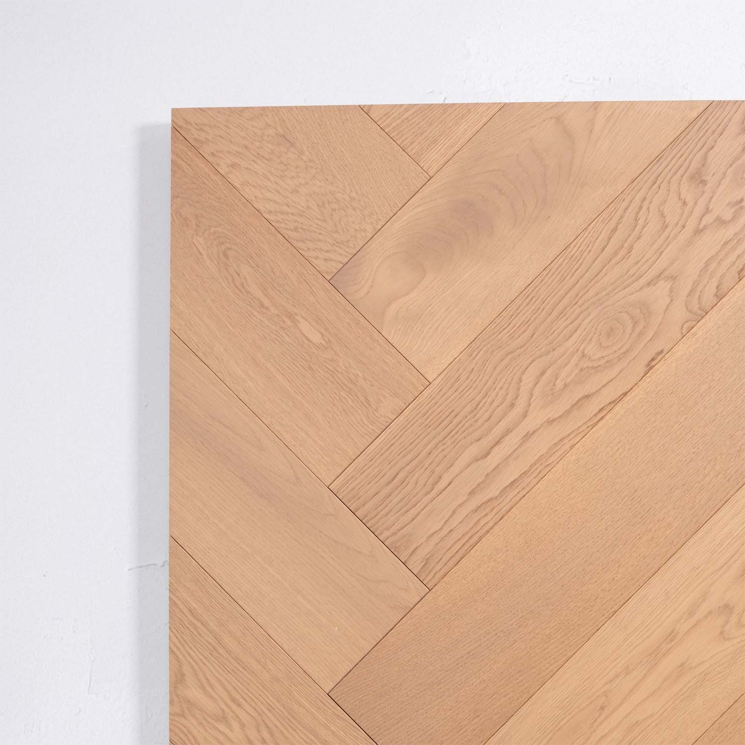 Angled view of Light Neutral Engineered Timber Herringbone 15.3mm in Light Neutral colour light tone herringbone flooring sample