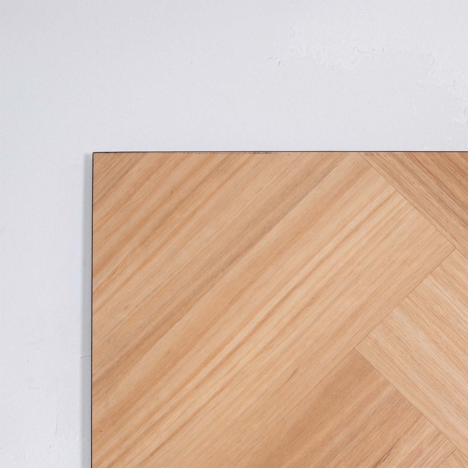 Side view of Natural Blackbutt SPC Hybrid Floorboards Herringbone 7.5+2mm in Natural Blackbutt colour dark shade herringbone flooring sample