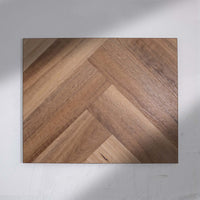 Angled view of Natural Spotted Gum SPC Hybrid Floorboards Herringbone 7.5+2mm in Natural Spotted colour warm tone herringbone flooring sample