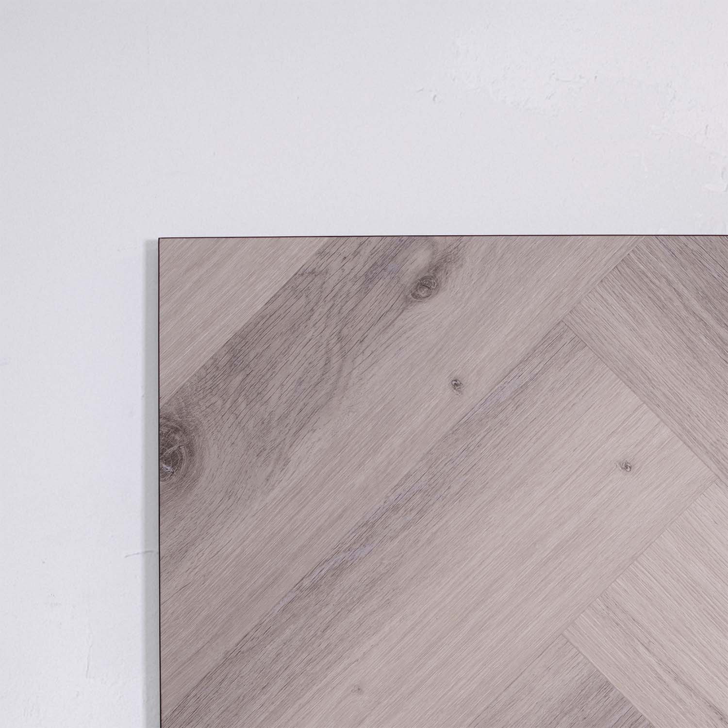 Side view of Snow Grey SPC Hybrid Floorboards Herringbone 7.5+2mm in Snow Grey colour light tone herringbone flooring sample